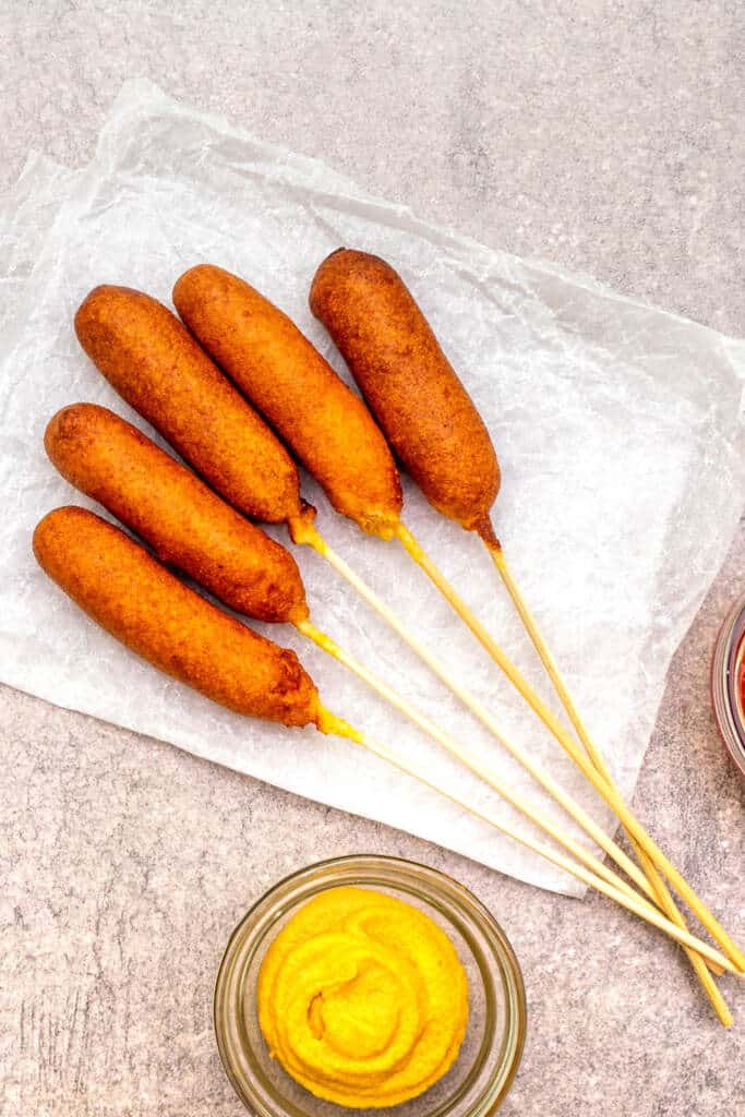 Friend homemade Corn dog with sticks on parchment paper