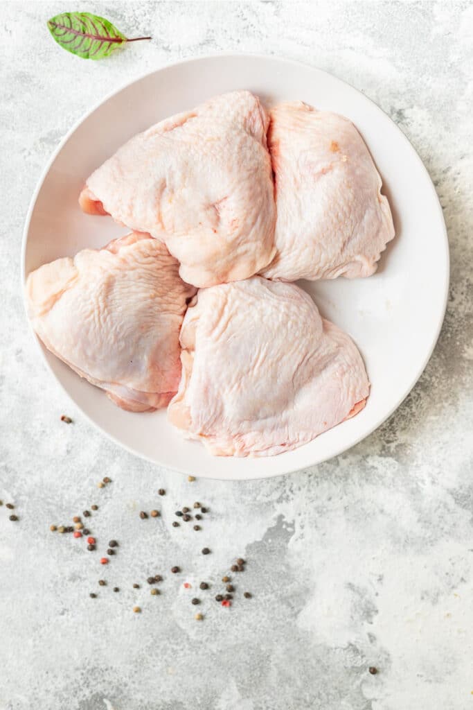 chicken thighs displayed nicely on white plate