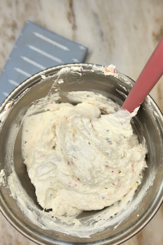 mixing dessert dip recipe in a large bowl