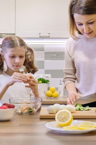Eating healthy on a tight budget mom and daughter preparing meal