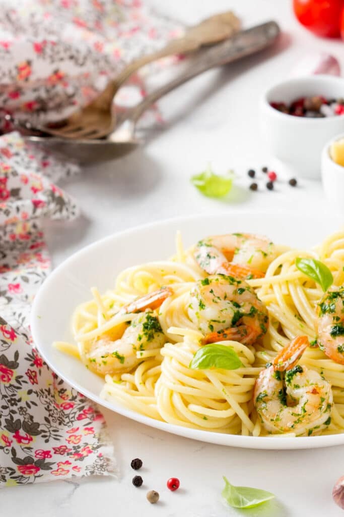 Shrimp scampi on white dinner plate