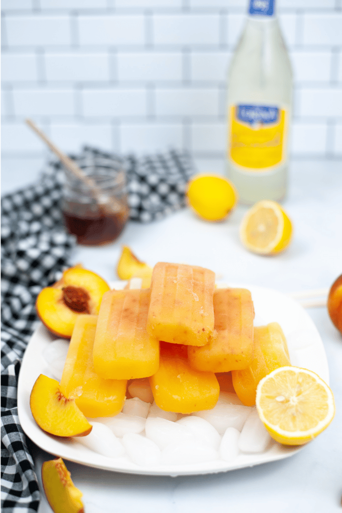peach popsicles on white plate