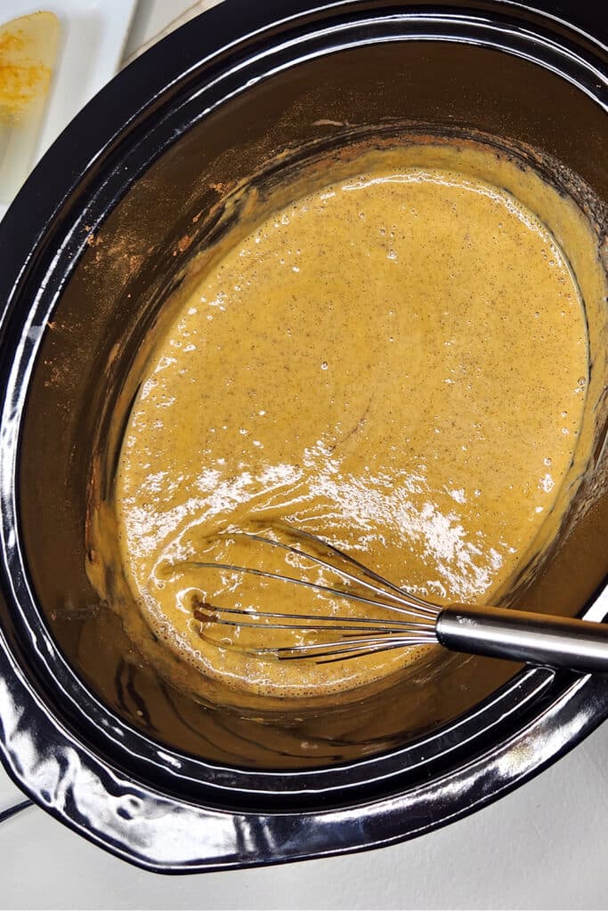 Mixing ingredients together for pumpkin bread pudding