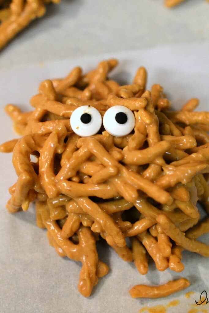 adding candy eyes to cookies