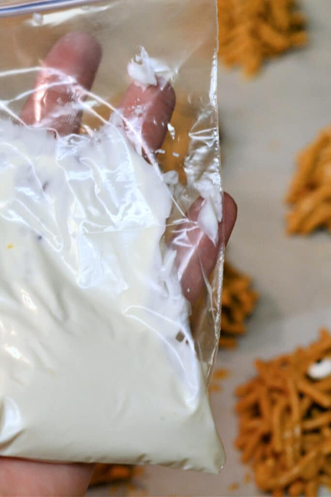 plastic bag with frosting in it. easy halloween treats- no bake cookies