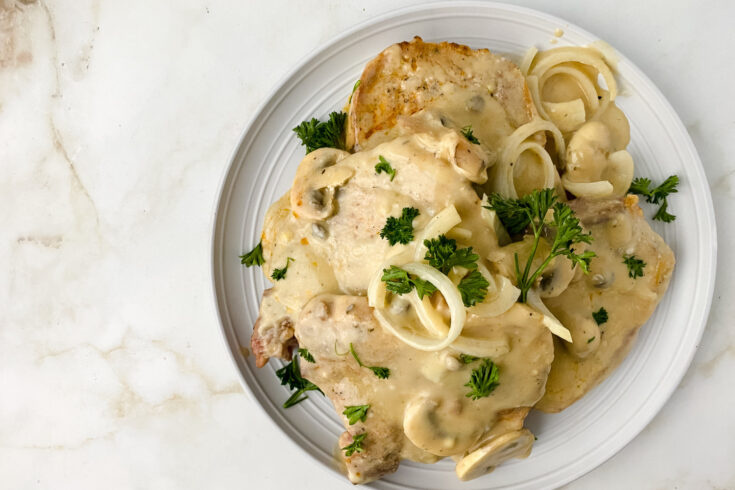 smothered pork chops on white plate 1