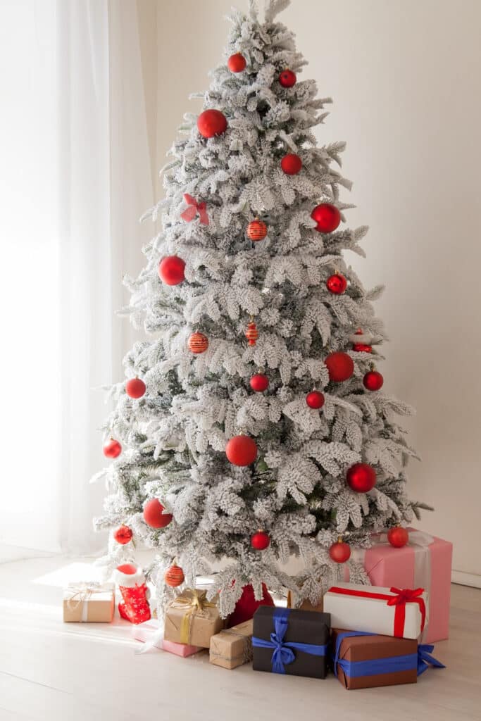 Flocked Christmas tree with red ornaments