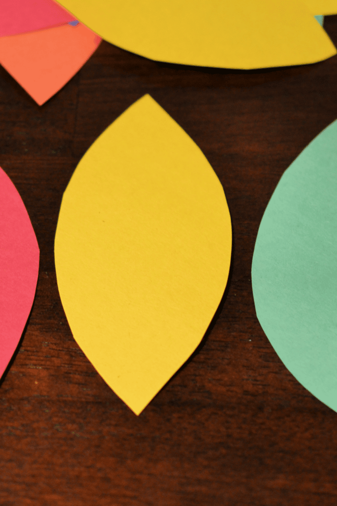 Cutting out tail pieces from construction paper in different colors