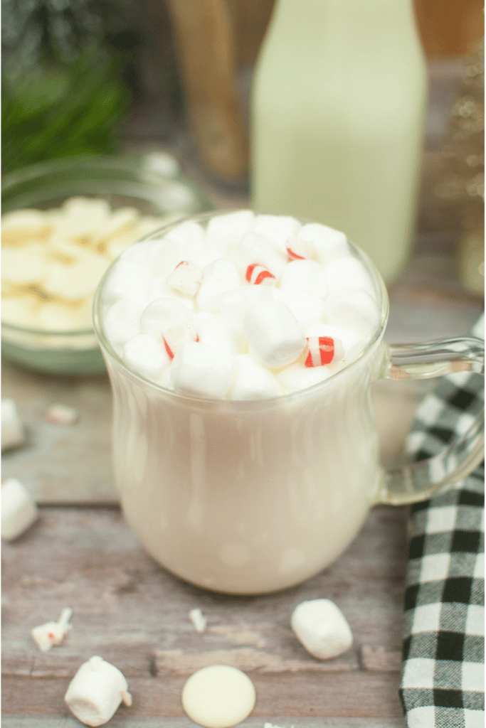 Homemade White Hot Chocolate finished pictured in clear glass mug on table