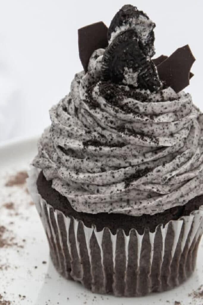 cookies and cream frosting on chocolate cupcake with extra stuffed cookies