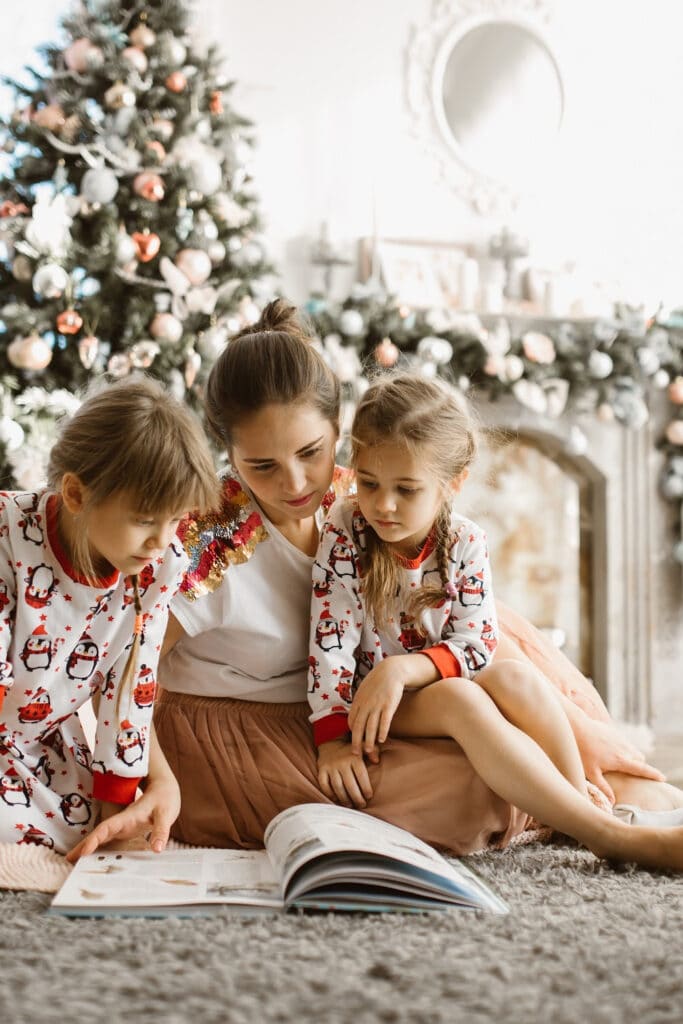 family reading book together at christmas