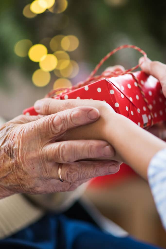 grandfather giving a present to grandchild