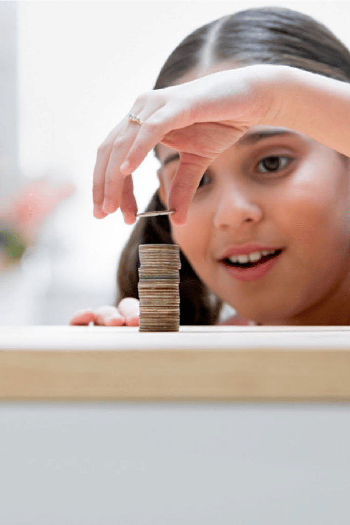 little girl stacking coins