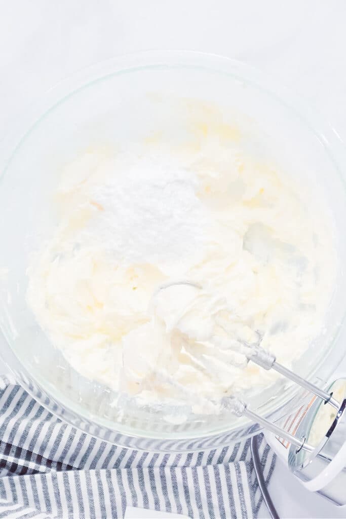 making buttercream frosting. Pictured whipped butter and cream cheese