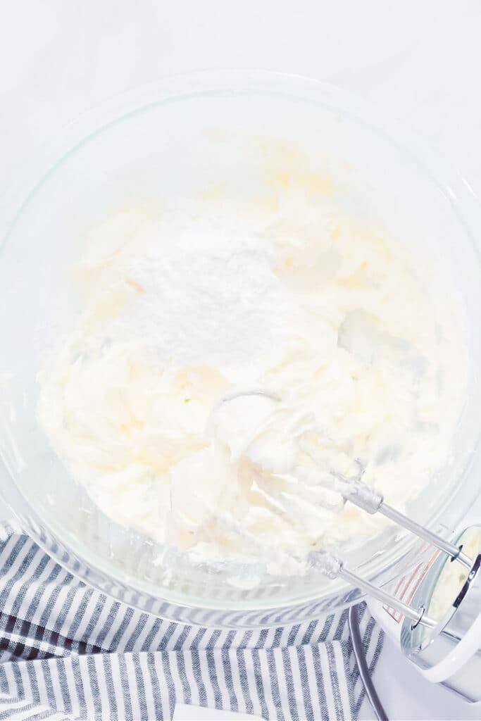 making fluffy buttercream frosting. Pictured whipped butter and cream cheese