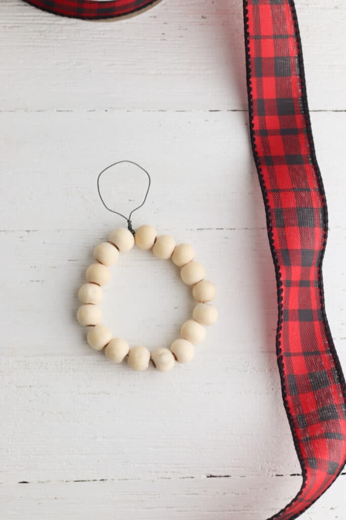 Make a wood bead ring. Picture of bead on wire in the form of a circle