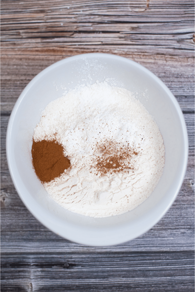 Mixing dry ingredients in white mixing bowl