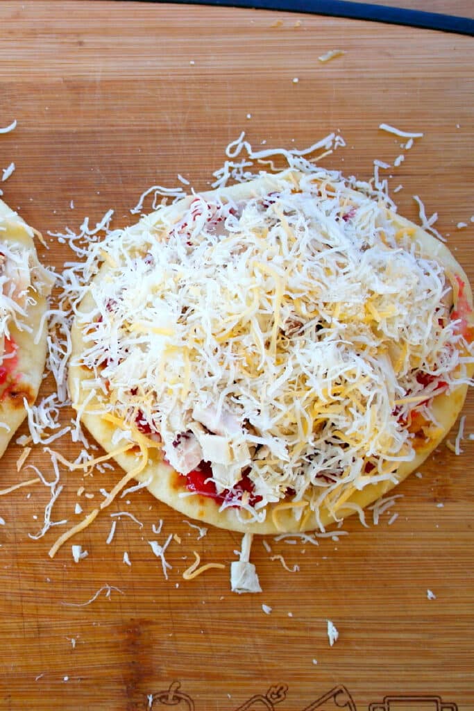 Sprinkling cheese on flatbread