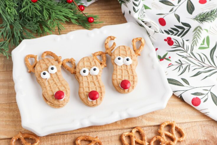 Three Nutter Butter Reindeer cookies on white platter
