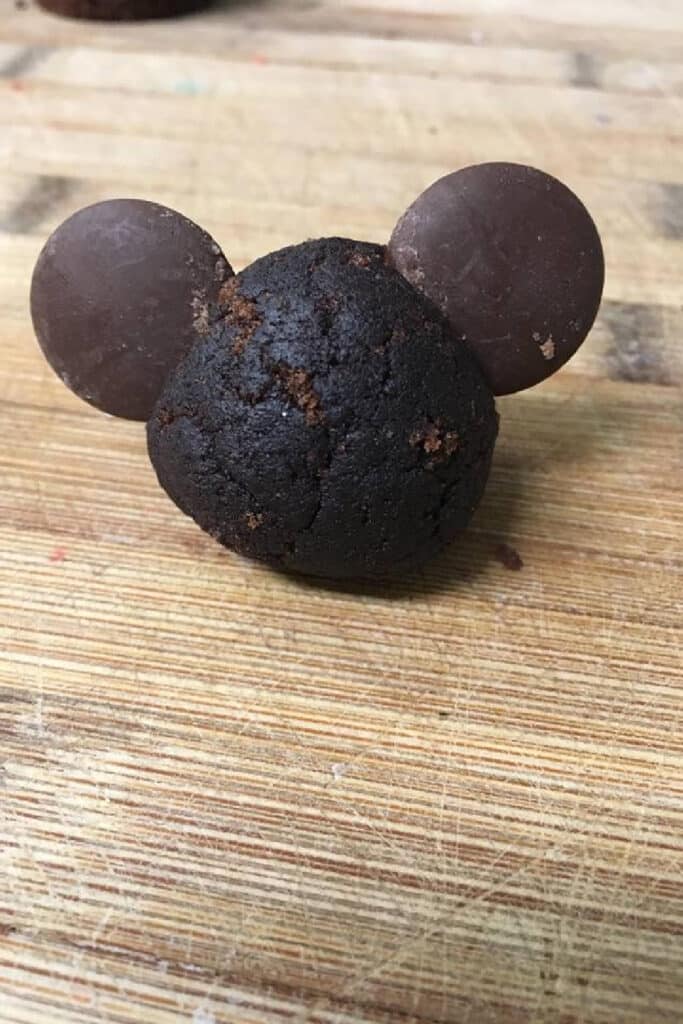 adding chocolate wafers to cake ball to make mickey mouse