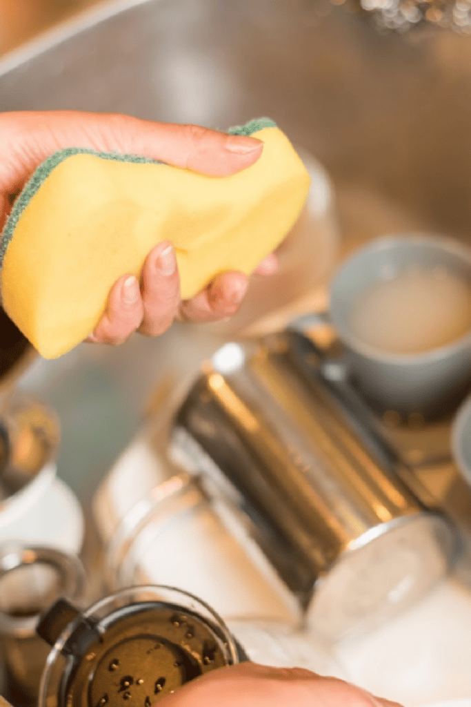 cleaning dishes in sink