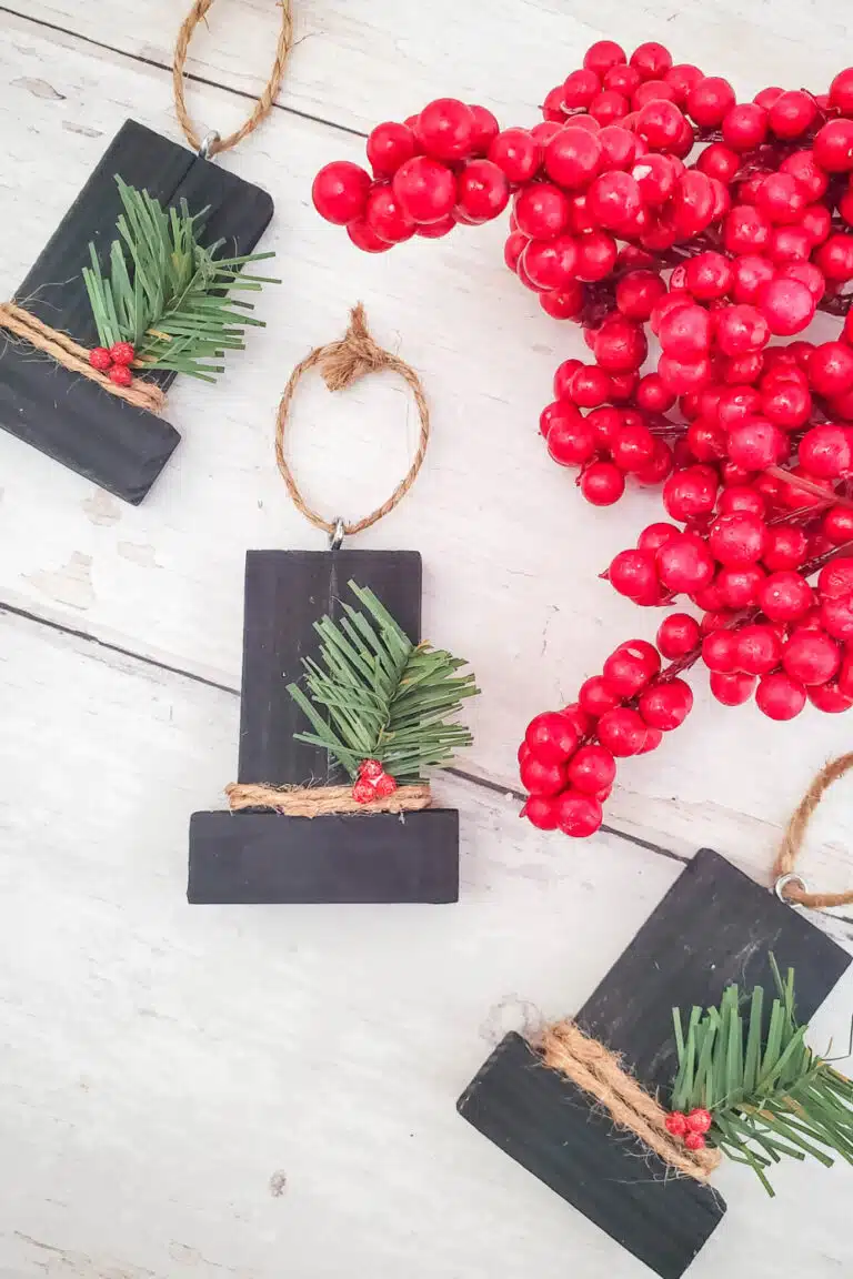 three finished snowman hats pictured on white background with holly