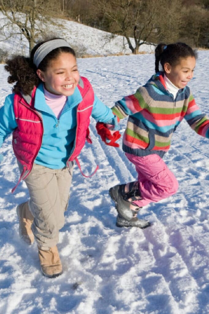 Two girls playing in the snow