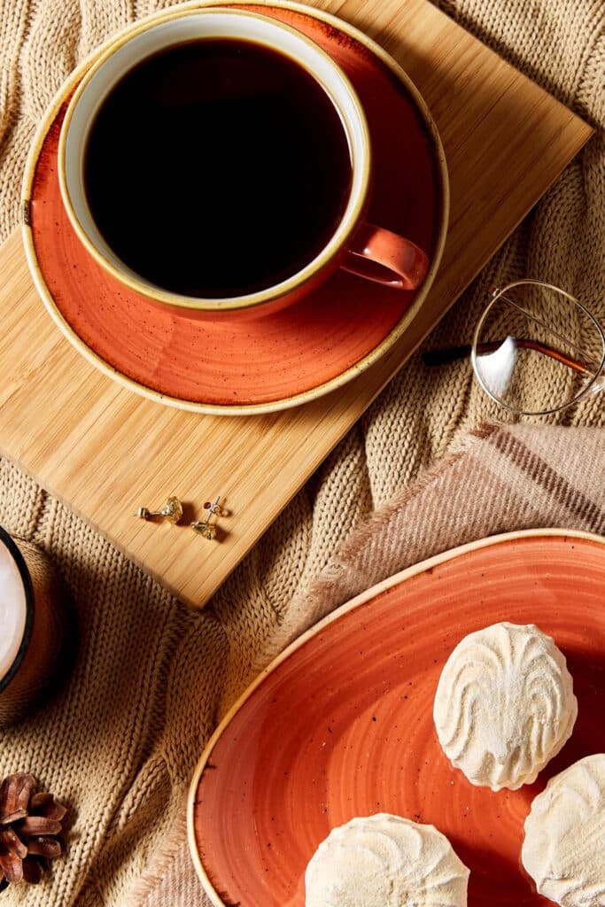 coffee cup and saucer on wood board