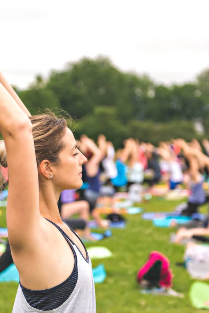 low cost workout class - woman doing yoga outside