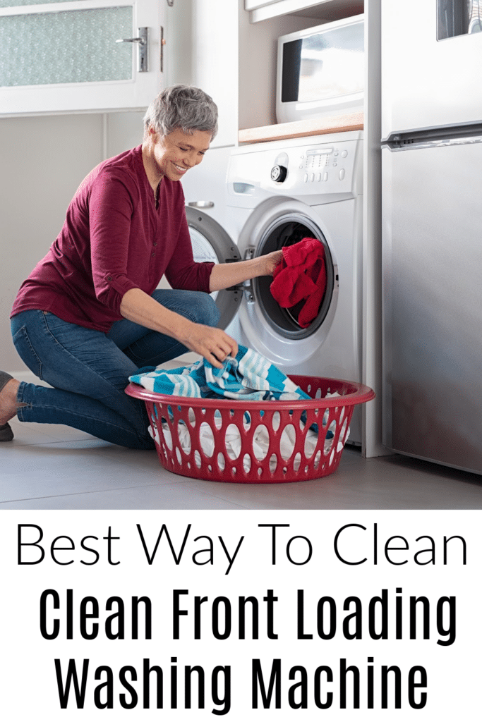 the best way to clean front loading washing machine -pictured woman bending down in fromt on laundry mache to empty it.