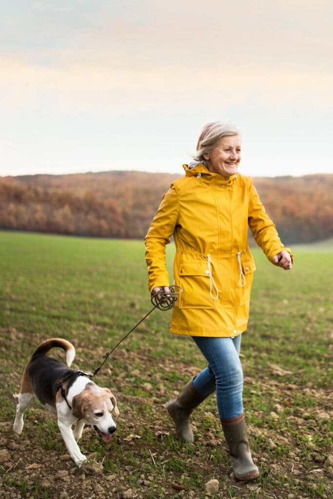 woman walking dog exercising on a budget