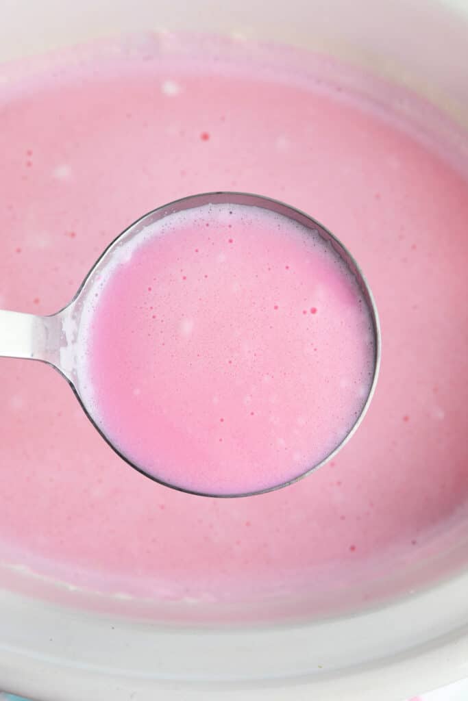 Adding pink food coloring to white hot chocolate