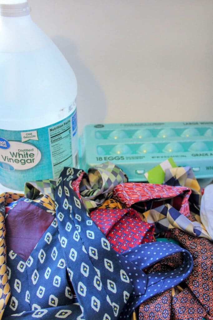 Vintage ties for egg dying, with a bottle of white vinegar