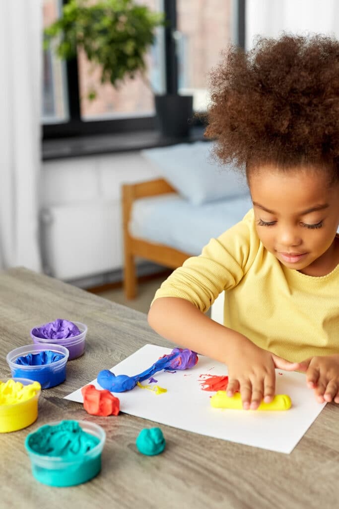 child playing with playdough