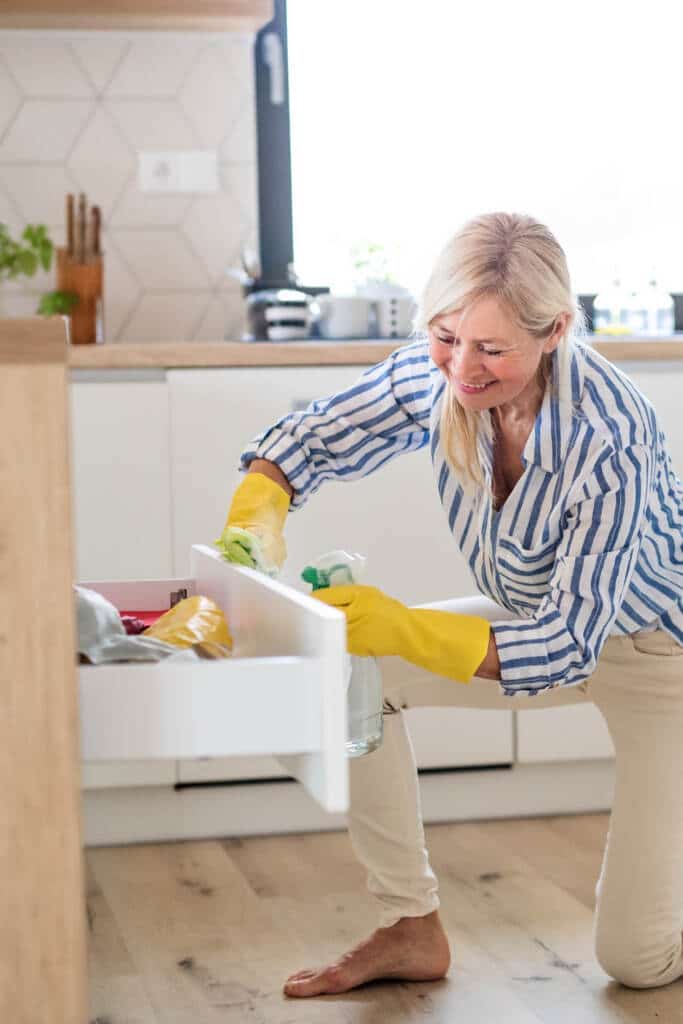 woman cleaning cabinets