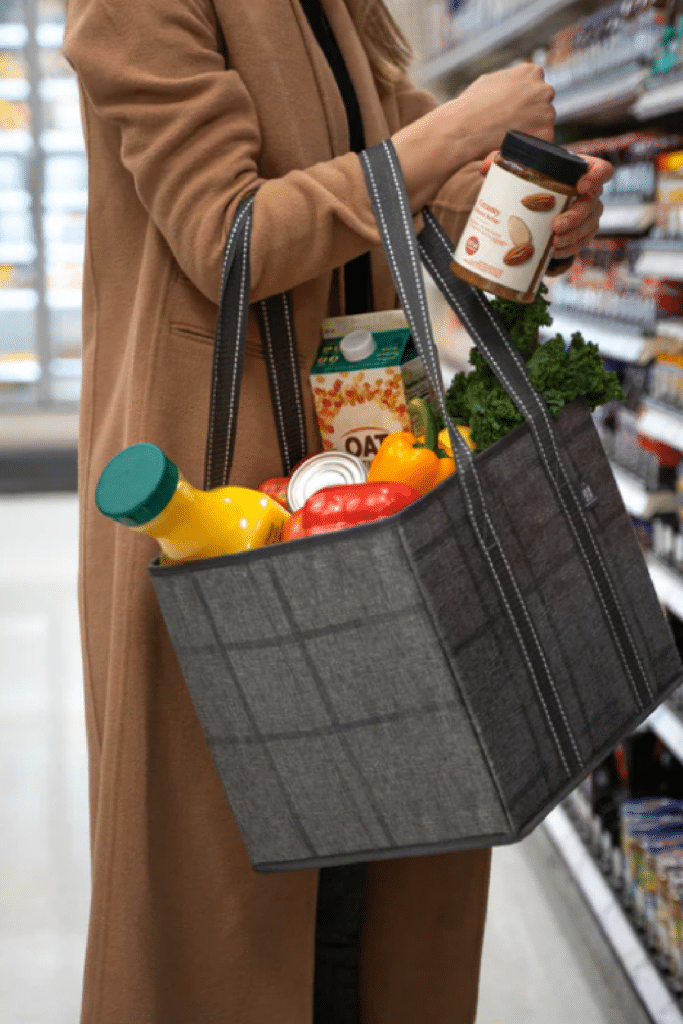 woman holding reusable shopping tote