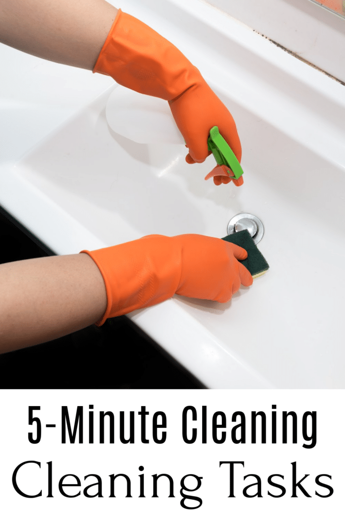 5 minute cleaning tasks - cleaning bathroom sink with rubber gloves and a sponge