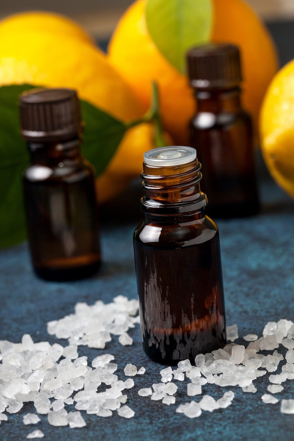 essentials oils - three bottles next to citrus fruit