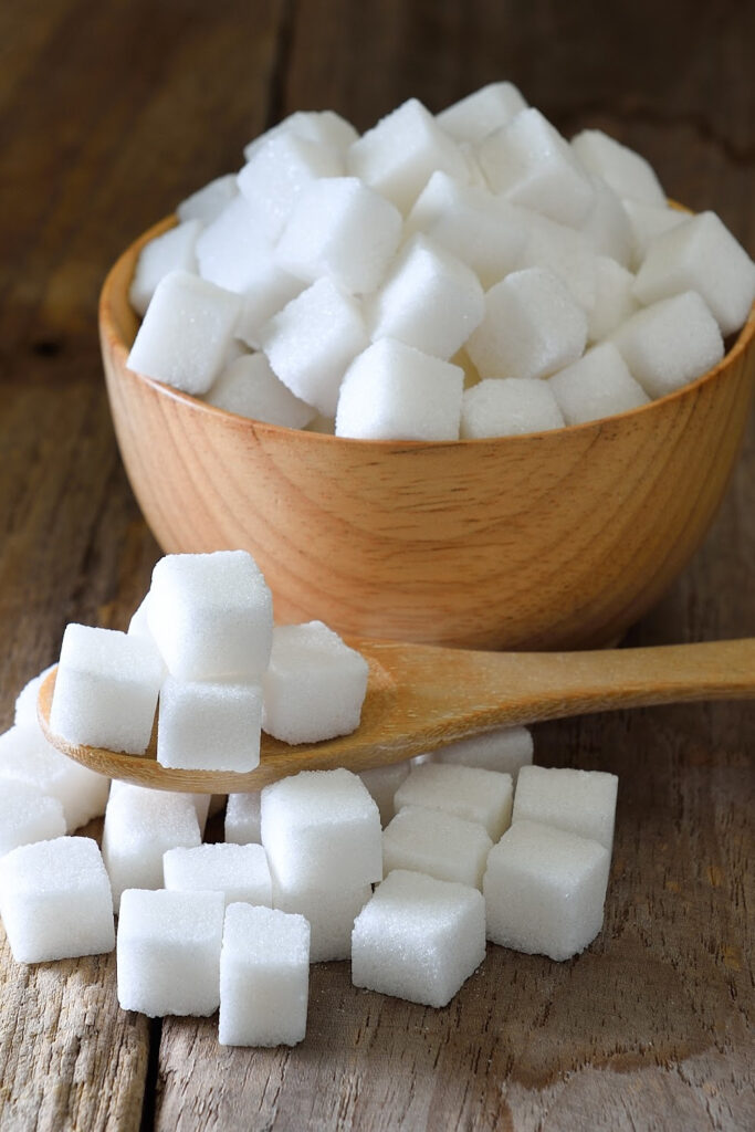 granulated sugar cubes in wooden bowl