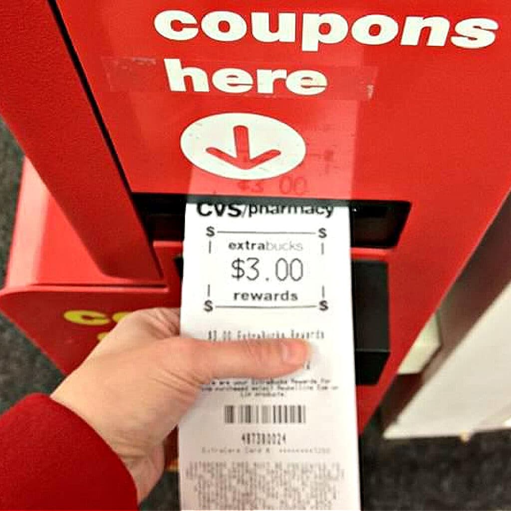 shopping with coupons at cvs - red coupon machine with CVS coupons on receipt slip