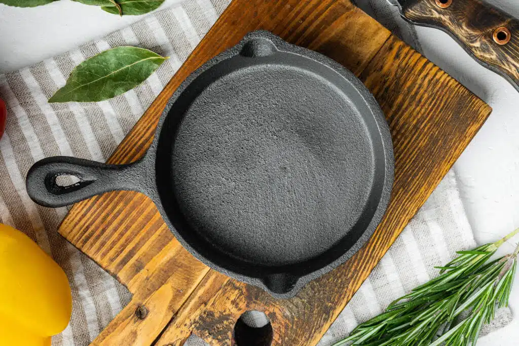 cast iron skillet on curring board