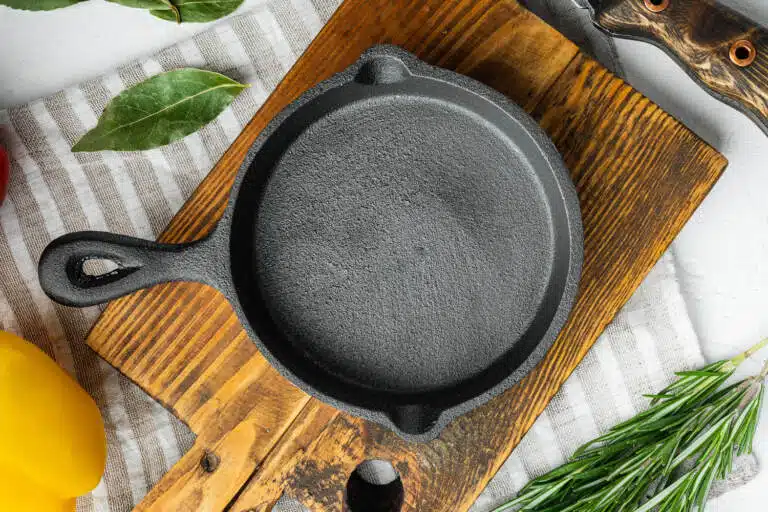 cast iron skillet on curring board