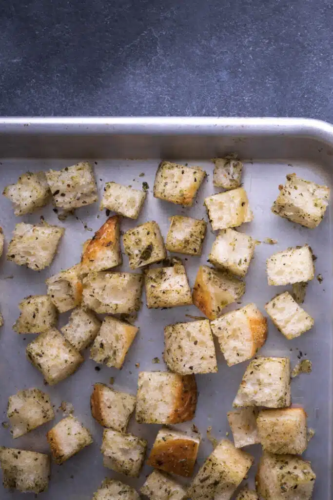 croutons from stake bread - making croutons on baking pan with spices