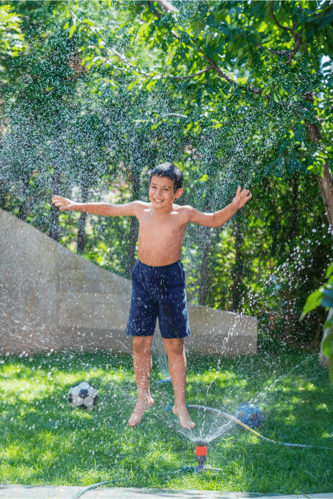 kids playing in the sprinkler