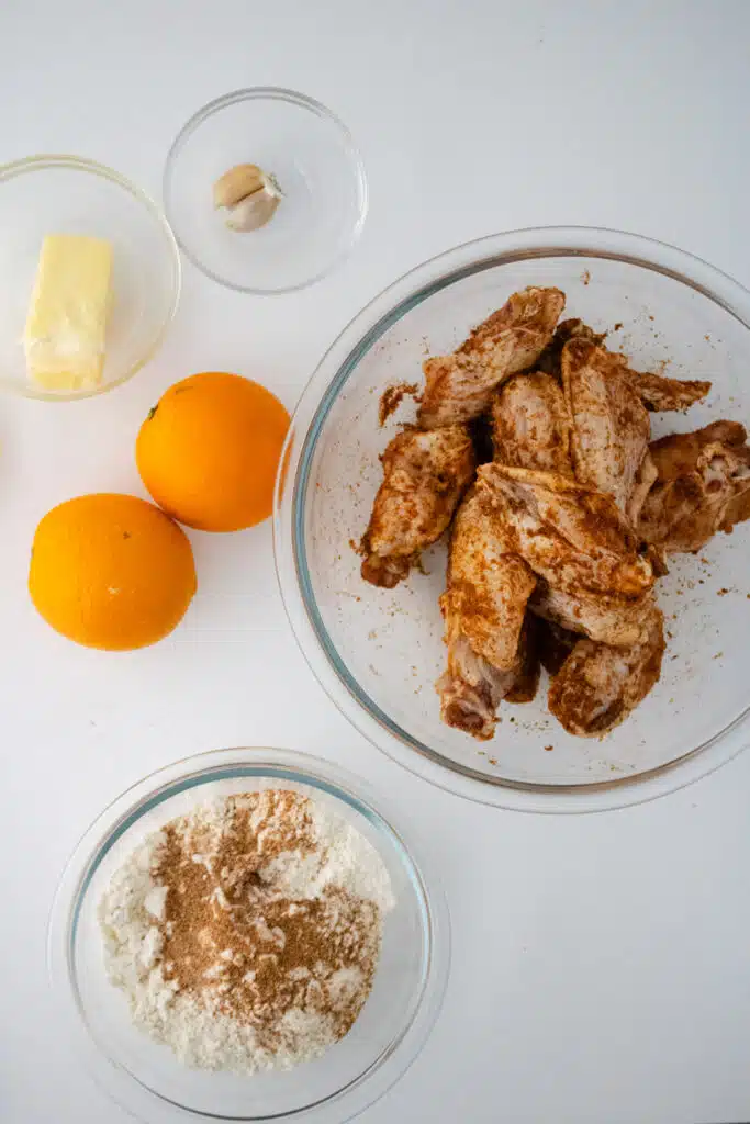 adding seasoning to chicken