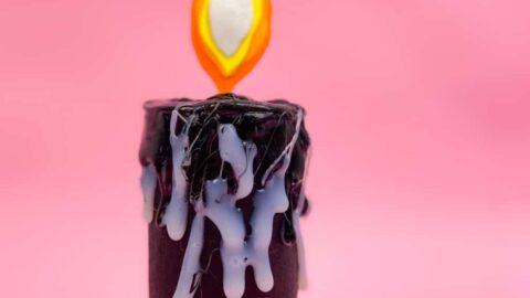 DIY Halloween Toilet Paper Roll Candle on pink background