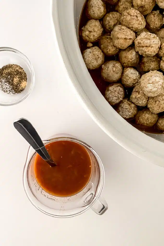 adding liquid to slow cooker for meatballs