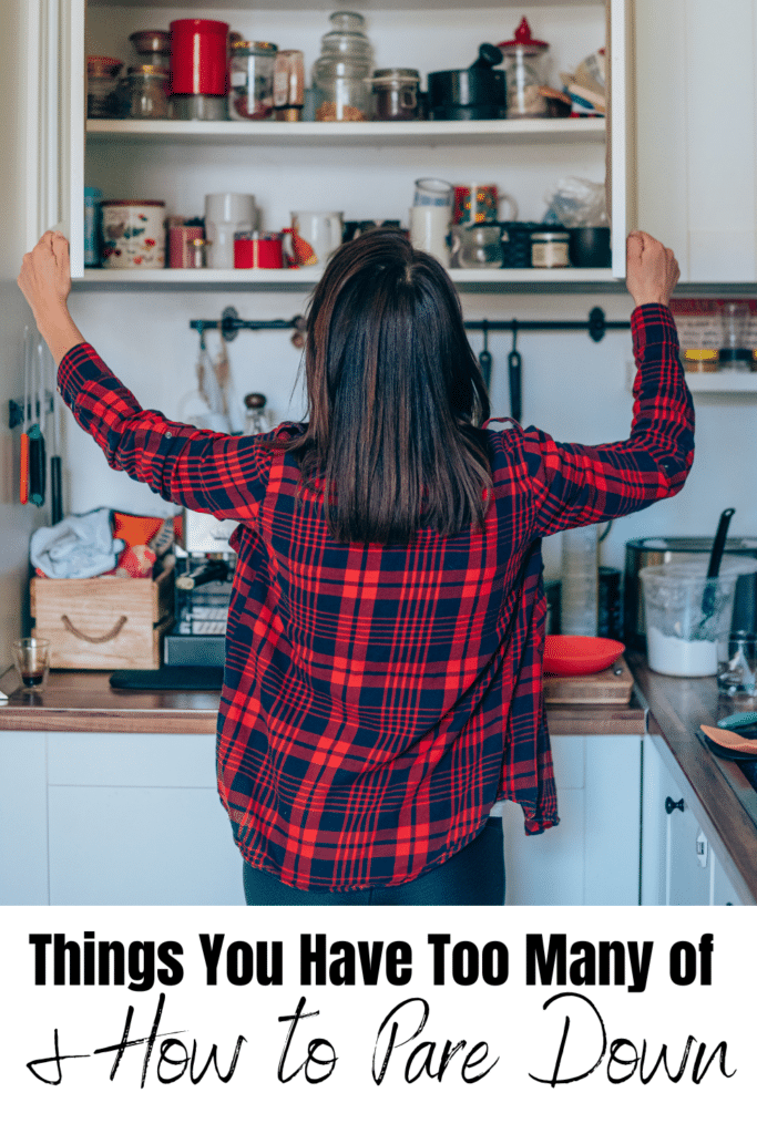 how to pare down -woman in kitchen opening kitchen cabinet