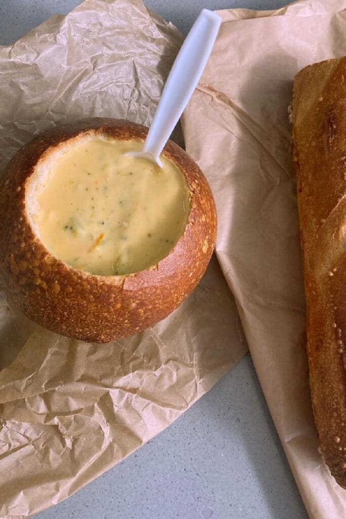 Panera bread bowl with soup and a plastic spoon