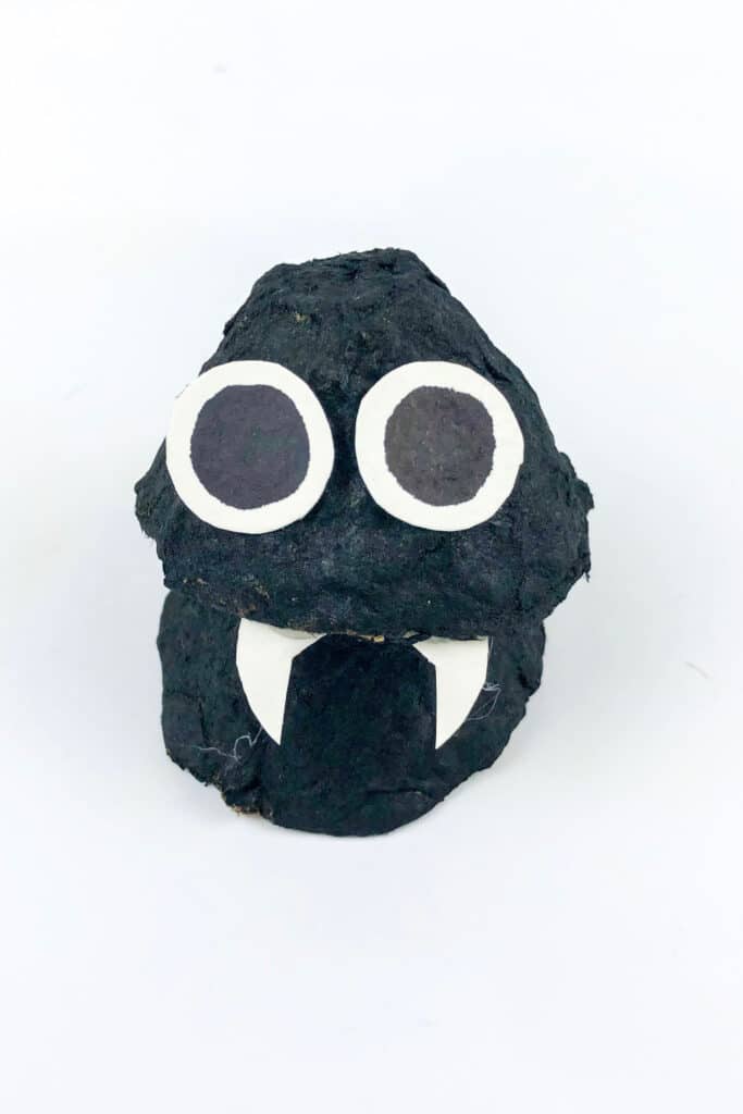 attaching eyes and fangs to black egg cups